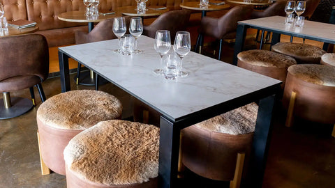 Compact Laminate Table Tops And Citadel Table Bases With Custom Kangaroo Hide Ottomans At Amor Wine Tapas Cocktails