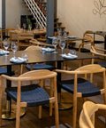 Glynis Armchairs Around Compact Laminate Tops And Carlita Table Bases At Georges On Waymouth