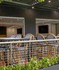 View Of Custom Tiled Tables And Jasmine Stools In Outdoor Dining Area At The Haus Restaurant