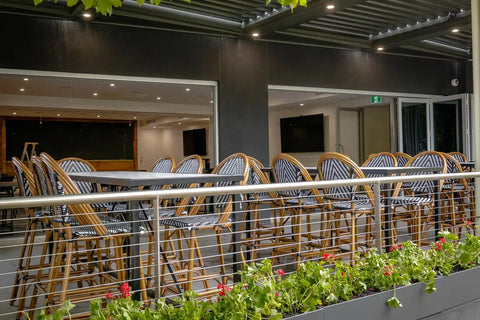 View Of Custom Tiled Tables And Jasmine Stools In Outdoor Dining Area At The Haus Restaurant