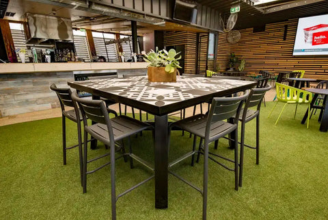 Marco Stools And Custom Tiled Table In The Outside Dining Area At Highlander Hotel