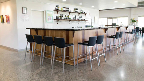 Black Vinyl James Bar Stools In Front Bar At Lambert Estate