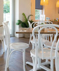 No 18 bentwood chairs in white with Elm table tops in natural and Filip table bases with Sienna Chairs in the background