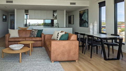 Living Dining Room, Featuring Custom Sofas, Custom Dining Table Artwork, And Cushions At The Kt Apartments