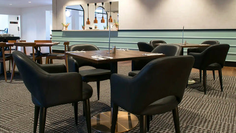 Mulberry Armchairs, Walnut Table Tops, And Carlita Table Bases At The Bridgeway Hotel
