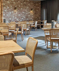 Sienna Natural Chairs With Carlton Round Table Bases And Natural Elm Table Tops At The Rezz Hotel 