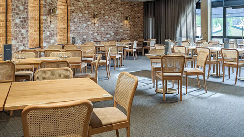 Sienna Natural Chairs With Carlton Round Table Bases And Natural Elm Table Tops At The Rezz Hotel