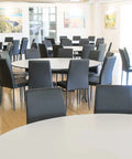Black Vinyl Adelaide Function Chairs With Black Legs And Compact Laminate Table Tops At Lambert Estate