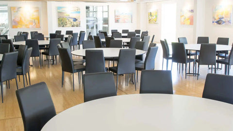 Black Vinyl Adelaide Function Chairs With Black Legs And Compact Laminate Table Tops At Lambert Estate
