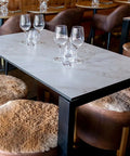 Compact Laminate Table Tops And Citadel Table Bases With Custom Kangaroo Hide Ottomans At Amor Wine Tapas Cocktails