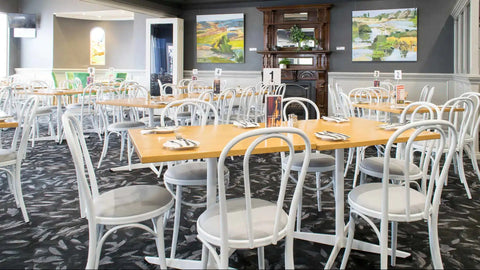 Custom Powdercoated White Coleman Bistro Chairs With Natural Rubberwood Tops And Davido Bases In The Main Dining Room At Kingsford Hotel