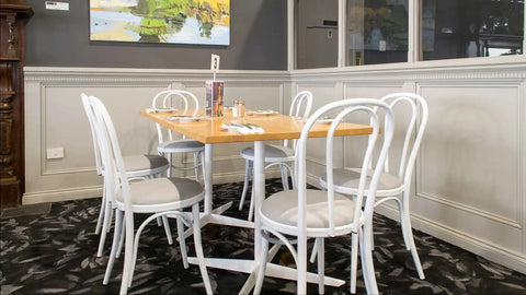 Custom Powdercoated White Coleman Bistro Chairs And Vinyl Seats With Natural Rubberwood Table Tops And Davido Bases In The Dining Room At Kingsford Hotel