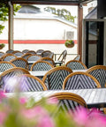 Custom Tiled Tabled And Jasmine Stools In Outdoor Dining Area At The Haus Restaurant