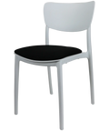 Monna Chair By Siesta In White With Black Seat Pad, Viewed From Angle