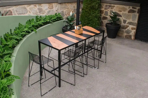 Jet Bar Stools and Custom Compact Laminate Table Tops On A Henley Table Base In The Outdoor Dining At The Gully Public House & Garden