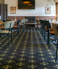 Indoor dining at The Hope Inn with upholstered dining chairs and timber tables.