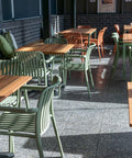 Outdoor terrace with timber tables and colourful chairs at The Hope Inn.