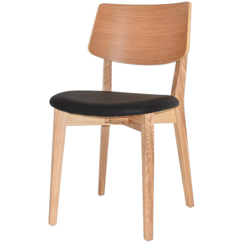 Vinnix Dining Chair With Natural Timber Frame And Backrest With A Black Vinyl Seat, Viewed From Angle In Front