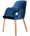 Alfi Armchair With Denim Velvet Shell And Trojan Oak Timber Legs, Viewed From Angle In Front