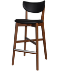 Romano Bar Stool With Black Vinyl Upholstered Backrest And Seat With Light Walnut Timber Frame, Viewed From Angle In Front